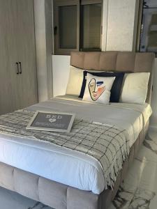 a bed with a sign on top of it at Sea View Apartment Patras in Patra