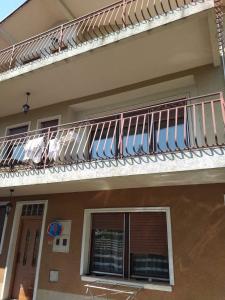 a balcony with umbrellas on the side of a house at Villa Kale Luxury in Skopje +3 photos