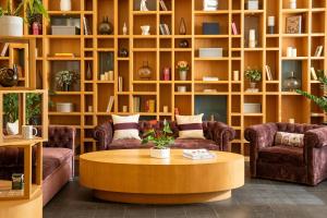 a living room with couches and a coffee table at INNSiDE by Meliá Prague Old Town in Prague