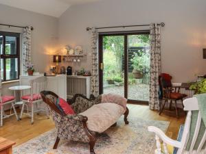 a living room with a chair and a table at Pink Granite Garden of Ireland in Killicreny Bridge +20 photos
