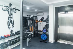 a room with a gym with weights and a mirror at Luxury Hotel Deluxe Room - Sleeps 2 - Gym - Pool in Lekki