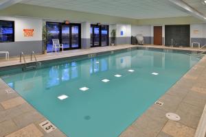 a large swimming pool with blue water at The Lodge at Big Sky in Big Sky