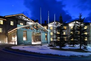 a building with trees in front of it at night at The Lodge at Big Sky in Big Sky