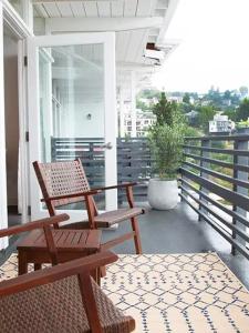 a porch with two chairs and a table and a plant at Hollywood Hills Hotel in Los Angeles