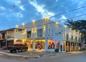 a truck parked in front of a white building at Del sur Apart Boutique in Mercedes Ibarra