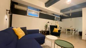 a living room with a blue couch and a table at Center underground studio in Bratislava
