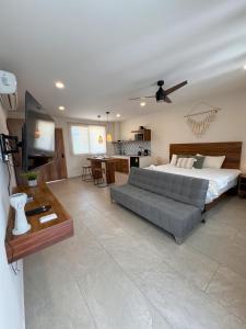 a living room with a bed and a couch at Santal Tulum Condo Hotel By Marea in Tulum
