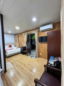 a bedroom with a bed and a desk in a room at Phúc Đạt Container in Vung Tau
