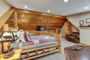 a bedroom with a bed in a room with wooden walls at second wind in Pigeon Forge