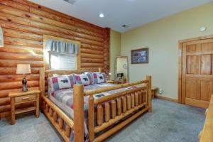 a bedroom with a bed and a wooden wall at second wind in Pigeon Forge +9 photos