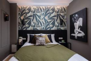 a bedroom with a bed with a painting on the wall at Villa with pool near sandy beach - by TRAVELER tourist agency Krk - ID 2224 in Privlaka +40 photos