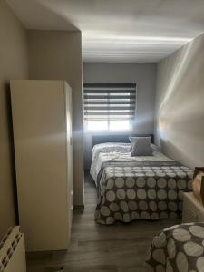 a bedroom with a bed and a window at Bungalow a 200 m de la Playa in Arenales del Sol +15 photos