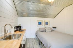 a small bedroom with a bed and a sink at Dumont Lake Studio Boat, Fish and Unwind! in Allegan