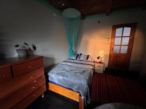 a bedroom with a bed and a dresser and a window at Wunderschönes Haus mit großer Terrasse in Sauce