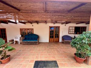 a patio with two chairs and a wooden ceiling at Wunderschönes Haus mit großer Terrasse in Sauce +17 photos