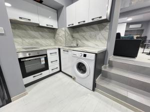 a kitchen with a washer and a washing machine at NJ Luxury Room in Varna City