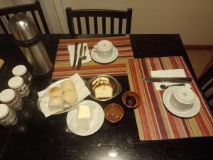 a table with plates of food on top of it at El Patio del Aromo in Puerto Madryn +7 photos