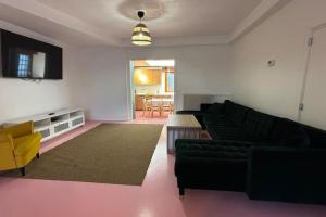 a living room with a couch and a table at Grande Maison 17 personnes in Arras
