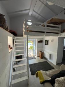 a room with a loft bed and a couch at Casa Oliva-Casa da Eira in Porto de Mós