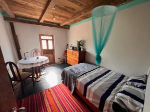 a bedroom with a bed and a table in it at Wunderschönes Haus mit großer Terrasse in Sauce +6 photos