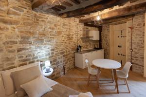 a kitchen with a table and a table and chairs at La Maison del Borgo in Castiglioni