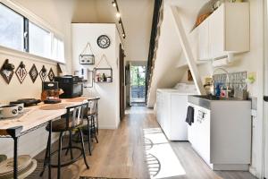 a kitchen with white cabinets and a counter at Hathaway Hideaway Loft Apartment in Hathaway Pines