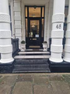 a front door of a building with a number on it at Cosy flat by Hyde Park- 15 in London