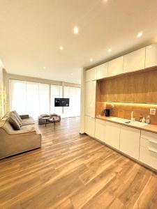 uma ampla sala de estar com um sofá e uma cozinha em Acropolis view em Atenas