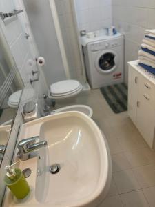 a bathroom with a sink and a washing machine at Casa Vacanze Primavera in Maratea +31 photos
