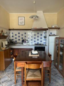 a kitchen with a wooden table and a stove at Casa Vacanze Primavera in Maratea