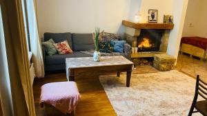 a living room with a couch and a fireplace at Oldtown apartment next of Town hall square in Kesklinn