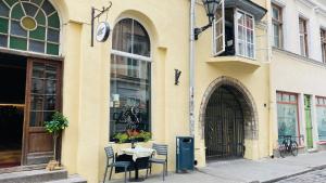 a table and chairs in front of a building at Oldtown apartment next of Town hall square in Kesklinn
