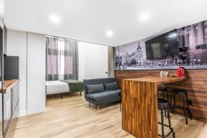 a living room with a bar and a couch at VR OBREGON APARTMENTS in Madrid