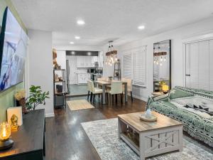 a living room with a couch and a table at Casa Hosum - 7 mins Downtown Sleeps 9 King Bed Fenced Yard in Houston