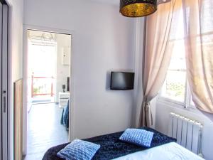 a bedroom with a bed with blue pillows and a mirror at La petite Maison in Grenoble