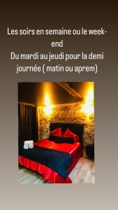 a bedroom with a red bed with red pillows at L’Aphrodizia love room in Barbaste