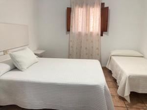 A bed or beds in a room at Cortijo Los Garridos - 8 huéspedes