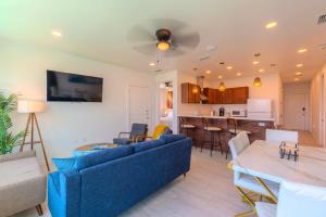a living room with a blue couch and a kitchen at Marisol Condo 301 in South Padre Island