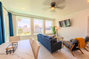 a living room with a blue couch and a table at Marisol Condo 301 in South Padre Island