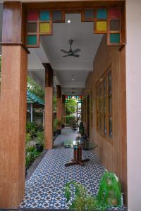 a hallway of a house with a table on a tile floor at Fort Kochi Paradise Homestay in Fort Kochi