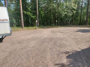 a dirt road with a truck parked on it at Majoitus jaetuissa huoneissa sisältäen ruokailut in Lappeenranta