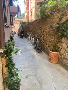 a group of bikes parked next to a stone wall at Luna D'Argento Apartment in Porto Ercole