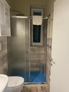 a shower with a glass door in a bathroom at Luna D'Argento Apartment in Porto Ercole +10 photos