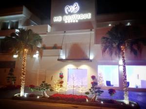 a store front with palm trees and a sign at MB Boutique Hotel - Adults Recommended in Nerja