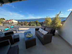 a patio with a couch and chairs on a balcony at Zana in Bol