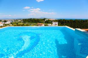 a large swimming pool with blue water at Apartments Bazar in Ulcinj