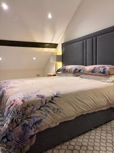 a bedroom with a large bed with a large headboard at The Cottage, Walworth Demesne in Ballykelly