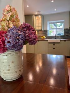 a vase filled with flowers sitting on a table at The Cottage, Walworth Demesne in Ballykelly