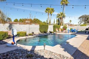 a swimming pool in a yard with palm trees at Nova Gypsy Vanner by PaseoHomesAZ with Pool & Pool in Phoenix +16 photos