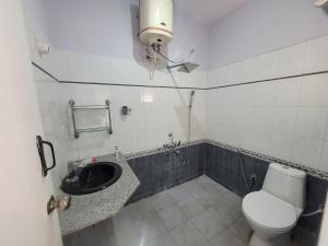 a bathroom with a toilet and a sink at Anusattva Vatika in Bengaluru +29 photos